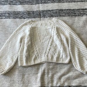 Sweater with wide sleeves.